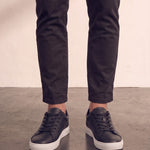 Men's Black Faux Leather Minimalist Low-Top Trainers, front view of the shoes, worn.
