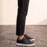 Men's Black Faux Leather Minimalist Low-Top Trainers, side view of the shoe, worn.