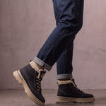 Men's Black Fleece-Lined Lace-Up Boots, the shoes in mid-step, showing the sole.