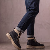 Men's Black Fleece-Lined Lace-Up Boots, the shoes in mid-step, showing the sole.