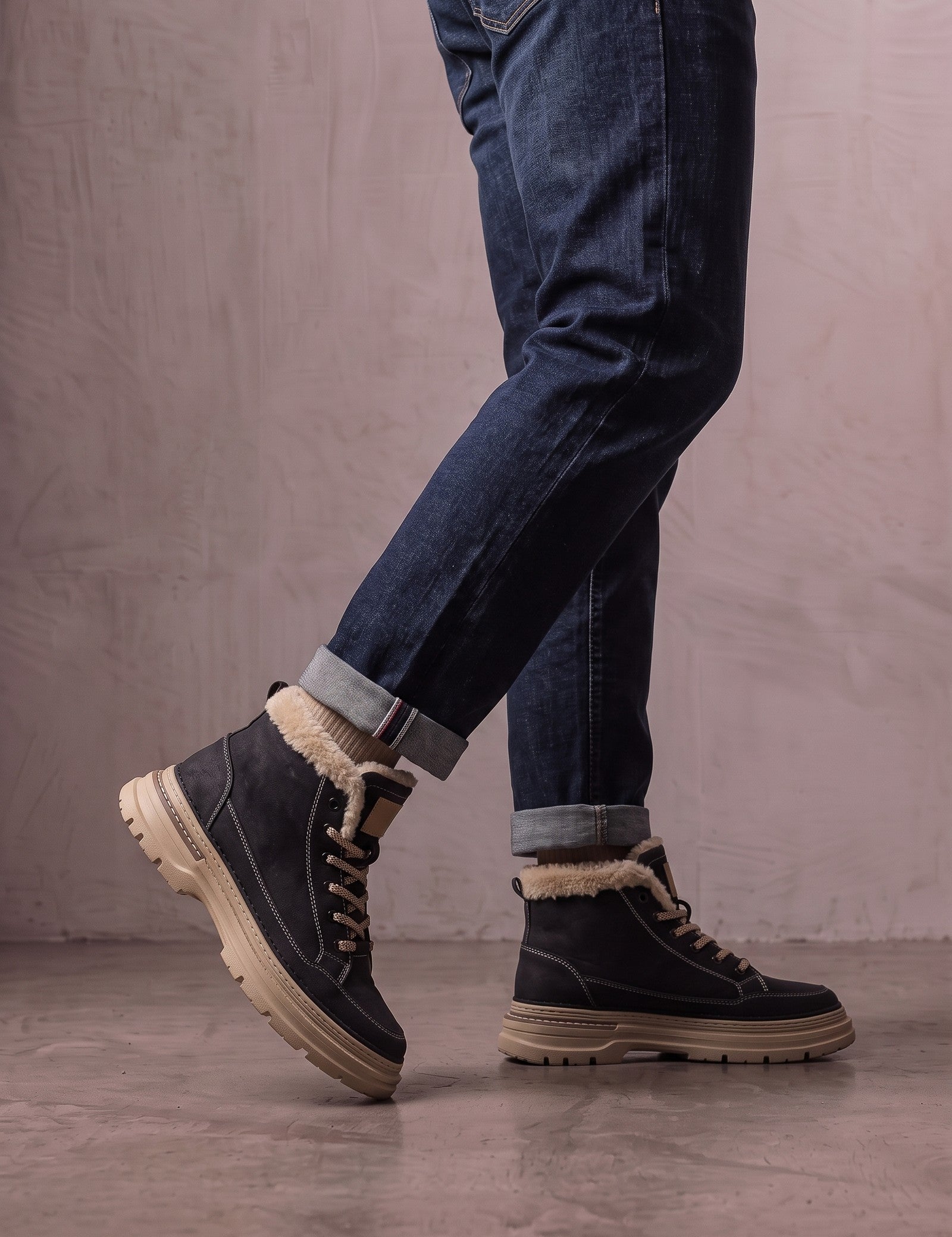 Men's Black Fleece-Lined Lace-Up Boots, the shoes in mid-step, showing the sole.
