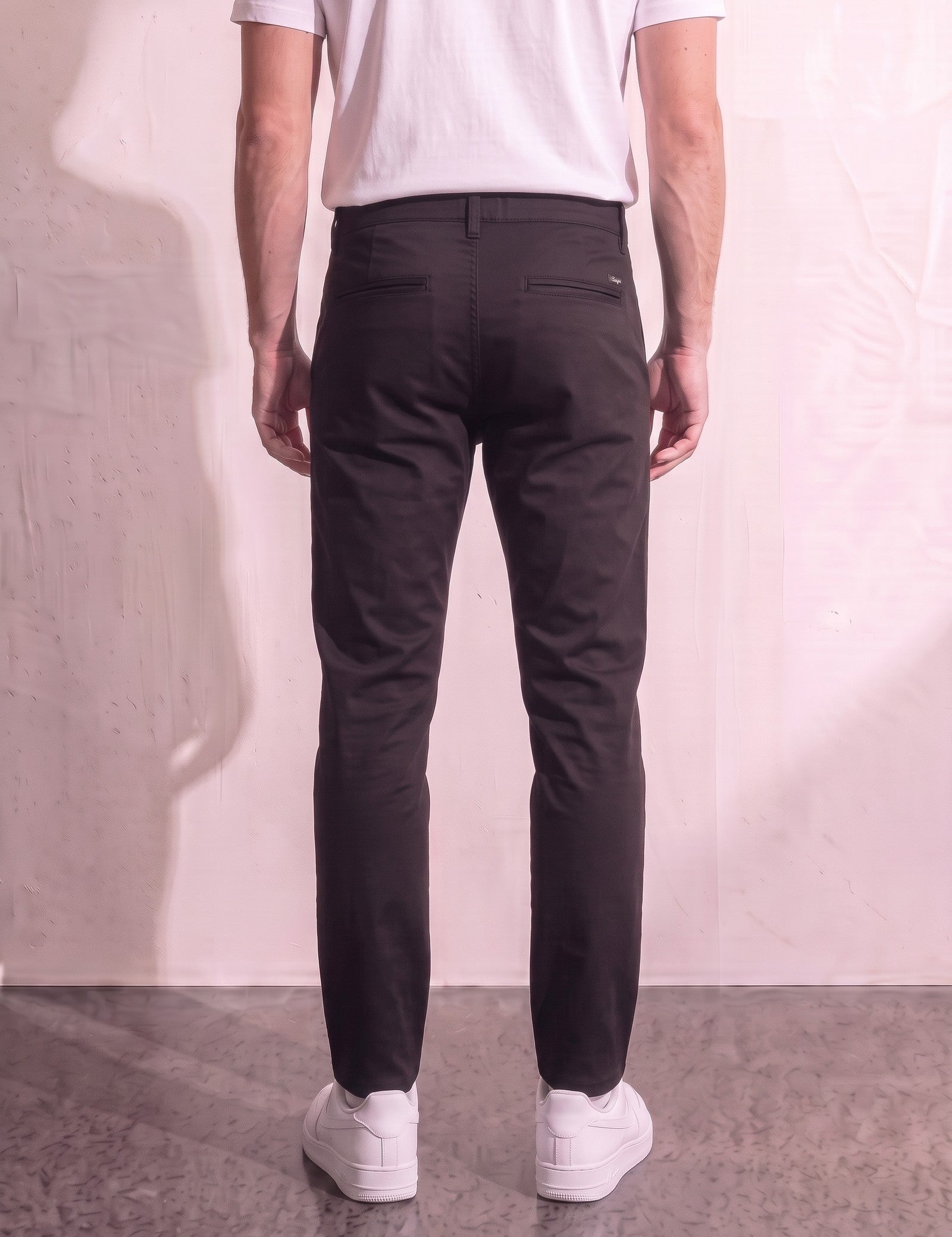 Men's Black Slim Fit Tapered Chino Trousers, back view from the waist down.