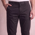 Men's Black Slim Fit Tapered Chino Trousers, close-up of the waistband and front pocket.