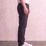 Men's Black Slim Fit Tapered Chino Trousers, side view from the waist down.