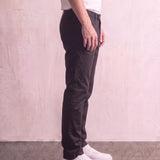 Men's Black Slim Fit Tapered Chino Trousers, side view from the waist down.