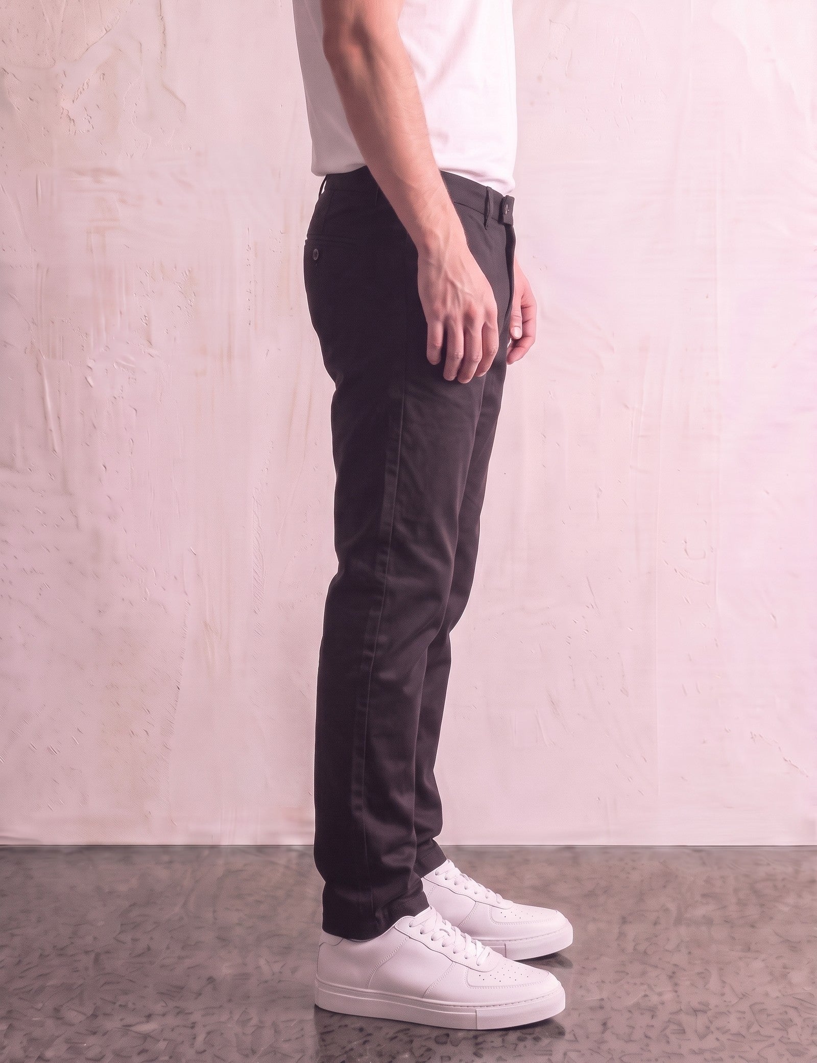 Men's Black Slim Fit Tapered Chino Trousers, side view from the waist down.