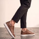 Men's Brown Low-Top Trainers, the shoes in mid-step, showing the sole.