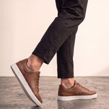 Men's Brown Low-Top Trainers, the shoes in mid-step, showing the sole.