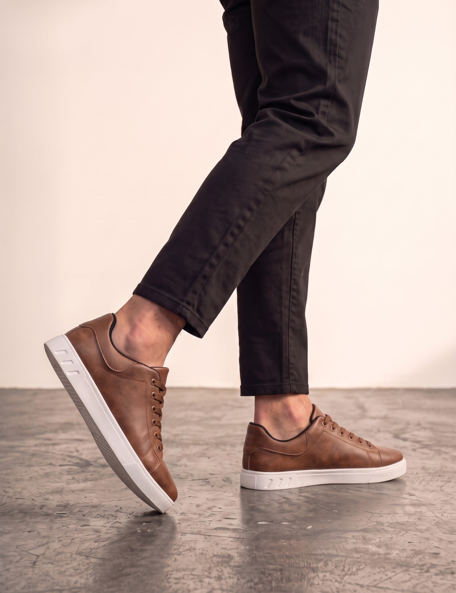 Men's Brown Low-Top Trainers, the shoes in mid-step, showing the sole.