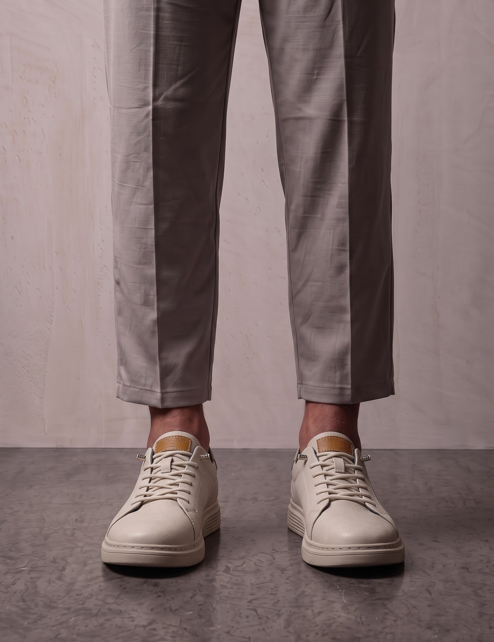Men's Taupe Faux Leather Low-Top Trainers, front view of the shoes, worn.