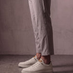 Men's Taupe Faux Leather Low-Top Trainers, side view of the shoe, worn.