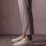 Men's Taupe Faux Leather Low-Top Trainers, side view of the shoe, worn.