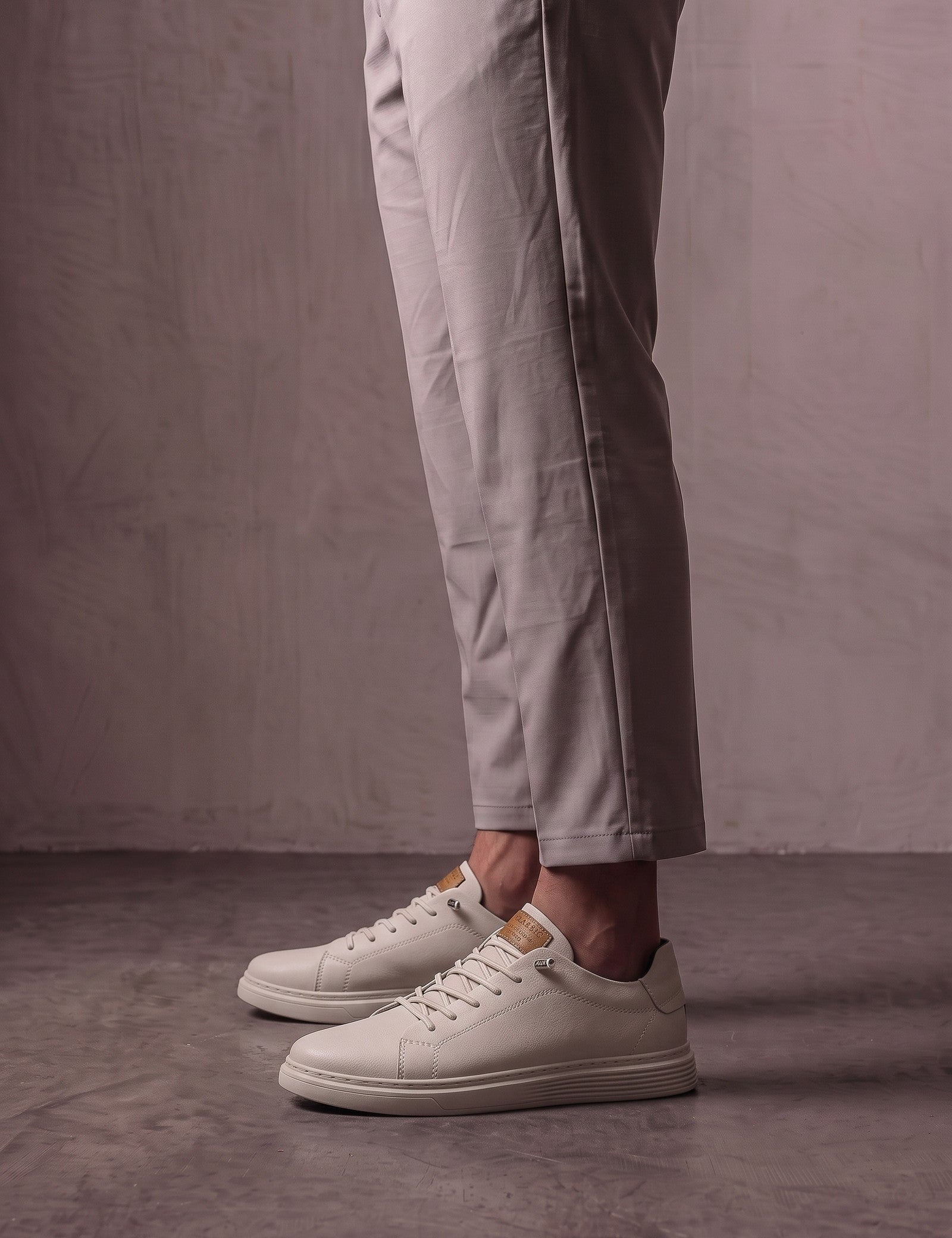 Men's Taupe Faux Leather Low-Top Trainers, side view of the shoe, worn.