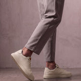 Men's Taupe Faux Leather Low-Top Trainers, the shoes in mid-step, showing the sole.