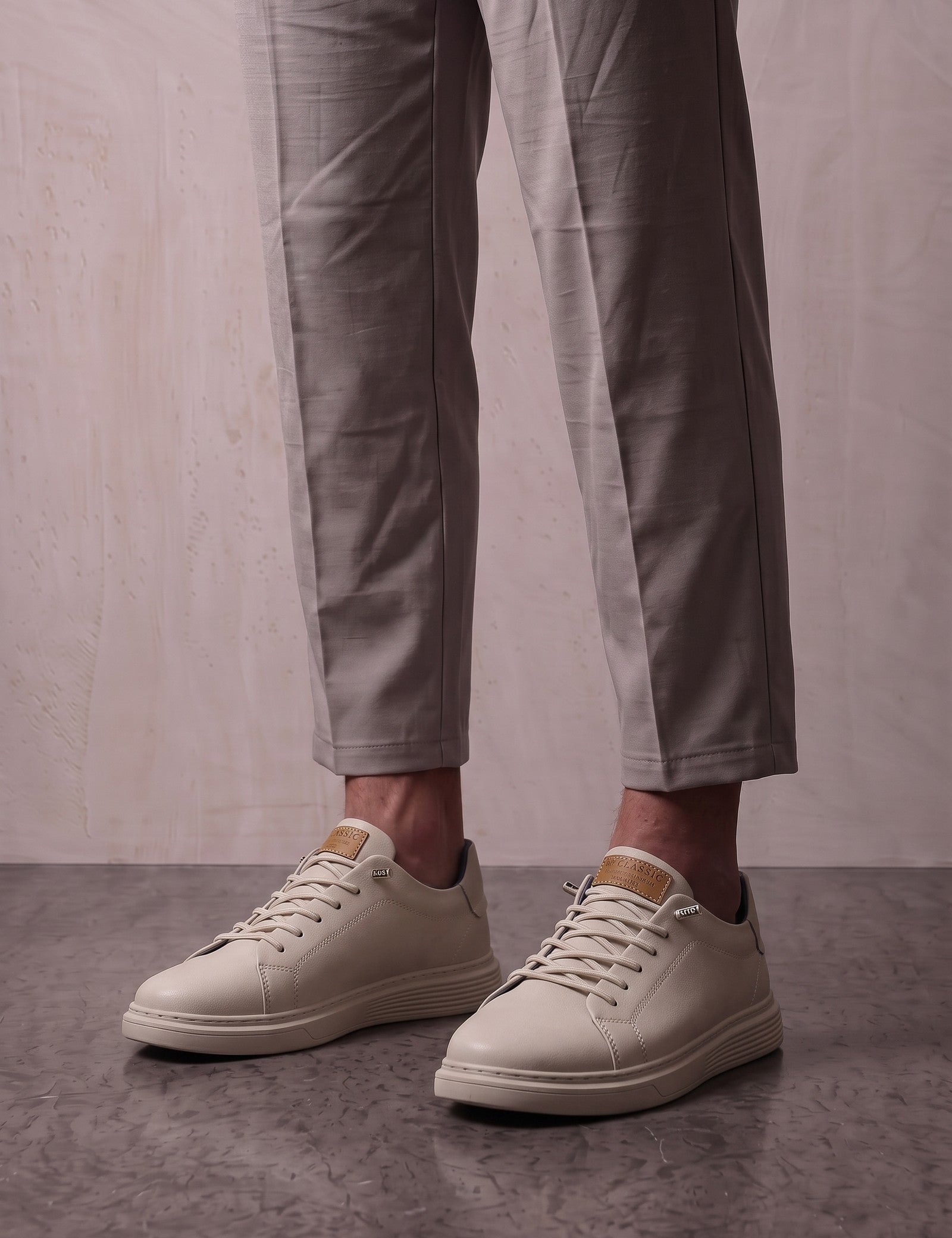 Men's Taupe Faux Leather Low-Top Trainers, three-quarter front view of the shoes, worn.