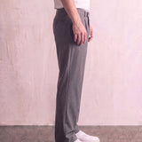 Men's Anthracite Pleated Straight-Leg Suit Trousers, side view from the waist down.