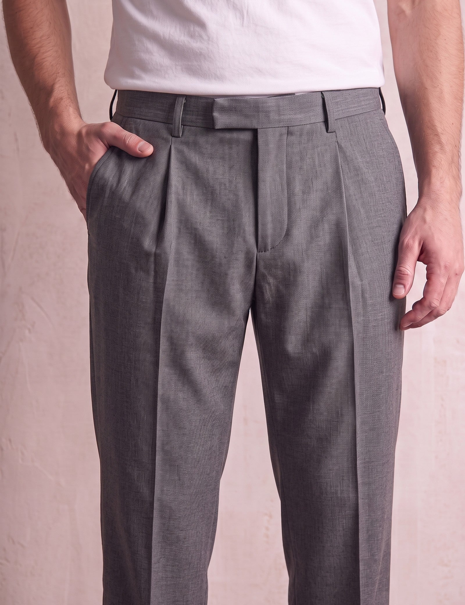 Men's Anthracite Pleated Straight-Leg Suit Trousers, close-up of the waistband and front pocket.