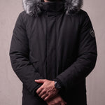 Men's Black Hooded Parka with Fur-Effect Trim, close-up of the upper body.