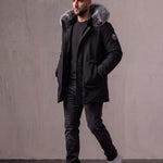 Men's Black Hooded Parka with Fur-Effect Trim, three-quarter view from the right, full length.