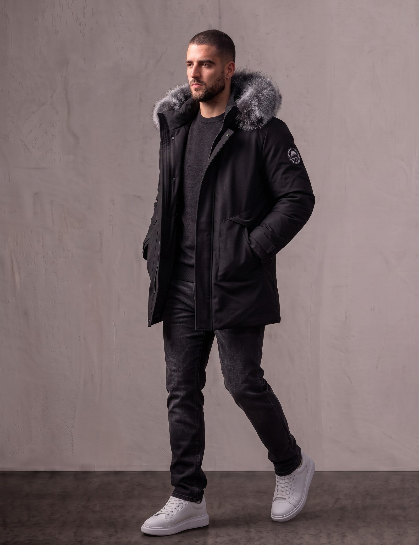 Men's Black Hooded Parka with Fur-Effect Trim, three-quarter view from the right, full length.