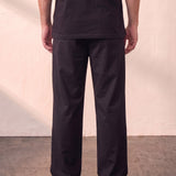 Men's Black Wide Leg Pleated Trousers, back view from the waist down.