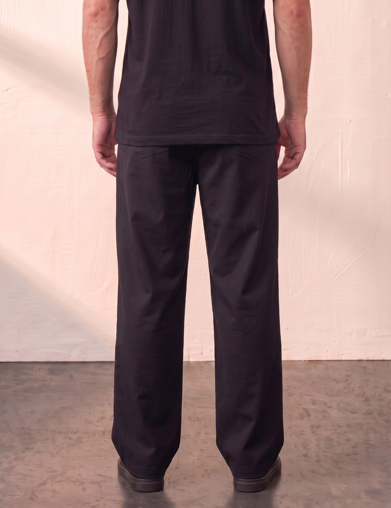 Men's Black Wide Leg Pleated Trousers, back view from the waist down.