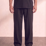 Men's Black Wide Leg Pleated Trousers, front view from the waist down.
