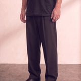 Men's Black Wide Leg Pleated Trousers, three-quarter view from the waist down.