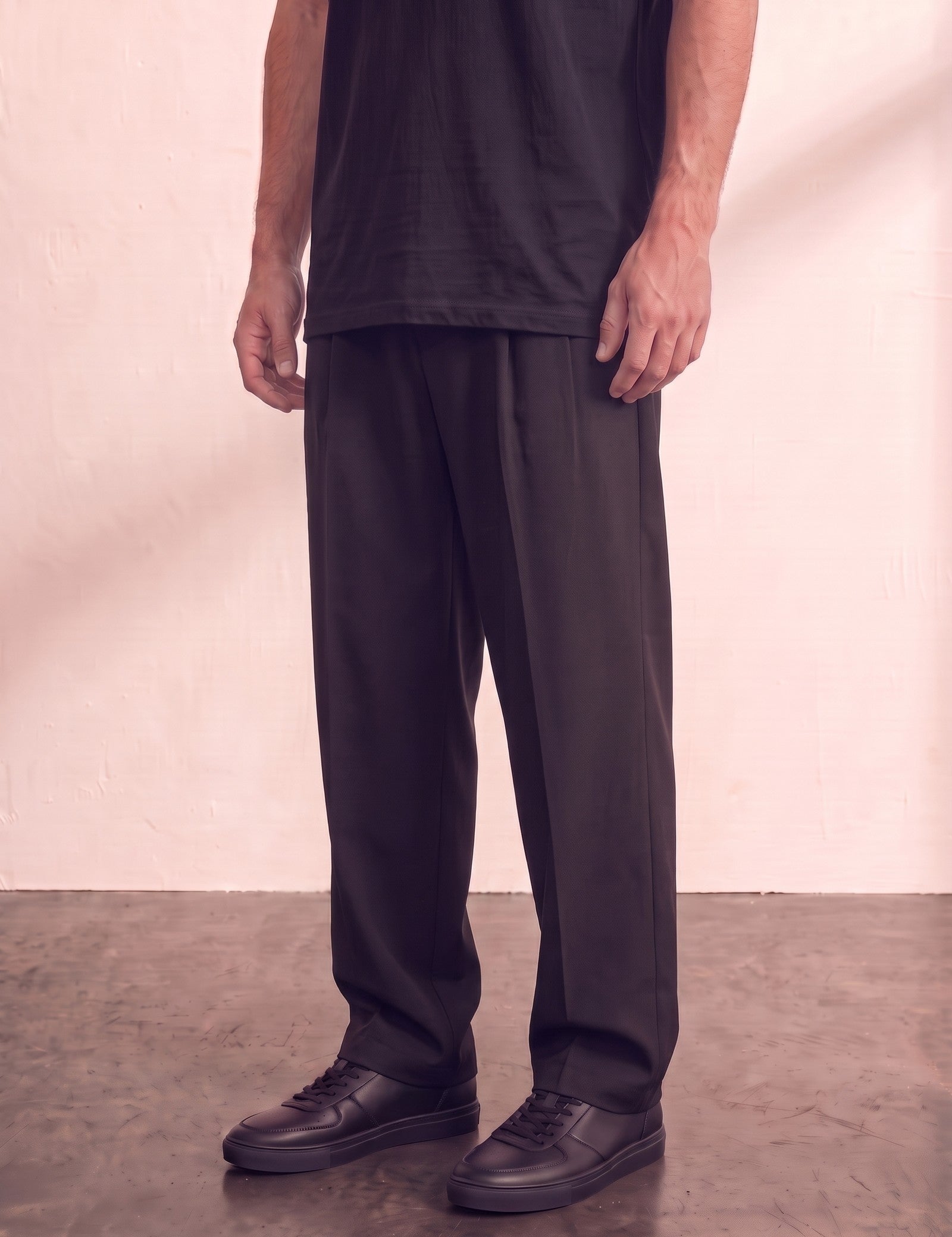 Men's Black Wide Leg Pleated Trousers, three-quarter view from the waist down.