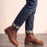 Men's Brown Distressed Lace-Up Mid-Top Work Boots, the shoes in mid-step, showing the sole.