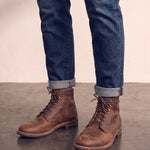 Men's Brown Distressed Lace-Up Mid-Top Work Boots, three-quarter front view of the shoes, worn.