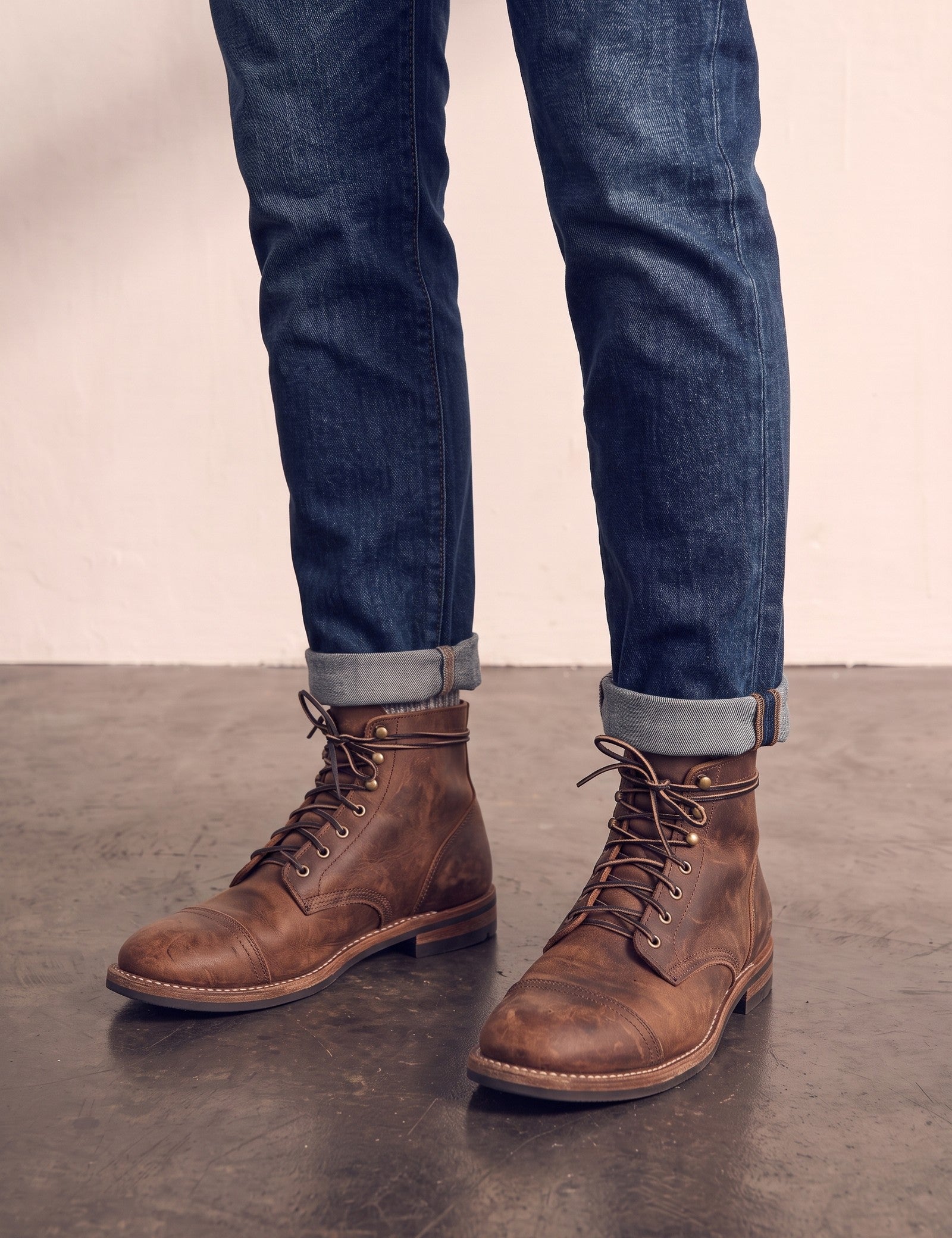Men's Brown Distressed Lace-Up Mid-Top Work Boots, three-quarter front view of the shoes, worn.