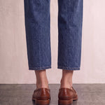 Men's Brown Penny Loafers with Moccasin Stitching, back view of the heels, worn.