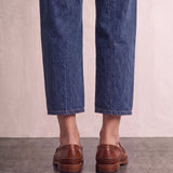 Men's Brown Penny Loafers with Moccasin Stitching, back view of the heels, worn.