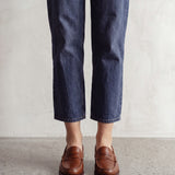 Men's Brown Penny Loafers with Moccasin Stitching, front view of the shoes, worn.