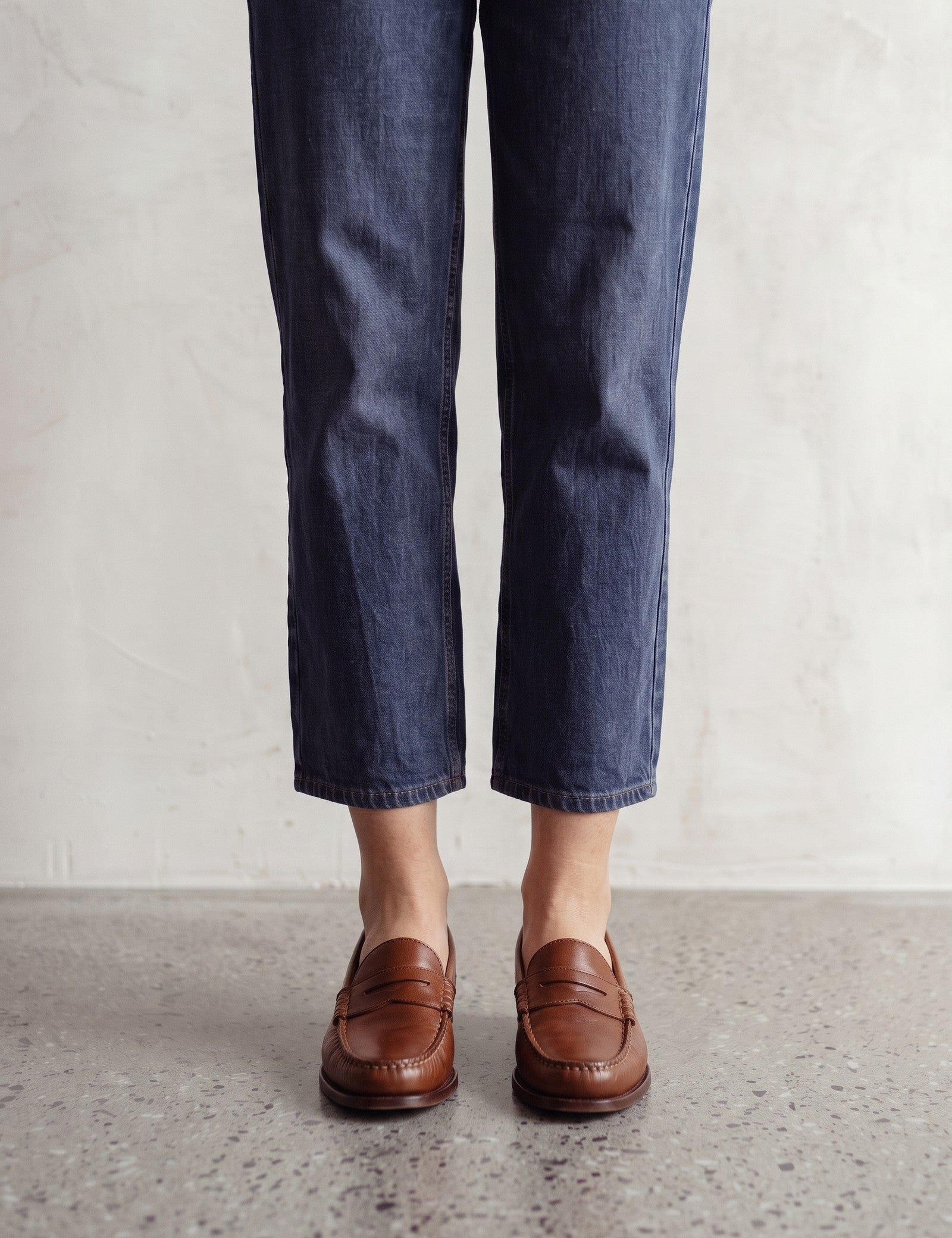 Men's Brown Penny Loafers with Moccasin Stitching, front view of the shoes, worn.