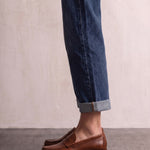Men's Brown Penny Loafers with Moccasin Stitching, side view of the shoe, worn.