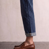 Men's Brown Penny Loafers with Moccasin Stitching, side view of the shoe, worn.