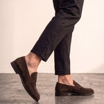Men's Brown Suede-Effect Penny Loafers, the shoes in mid-step, showing the sole.