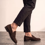 Men's Brown Suede-Effect Penny Loafers, the shoes in mid-step, showing the sole.