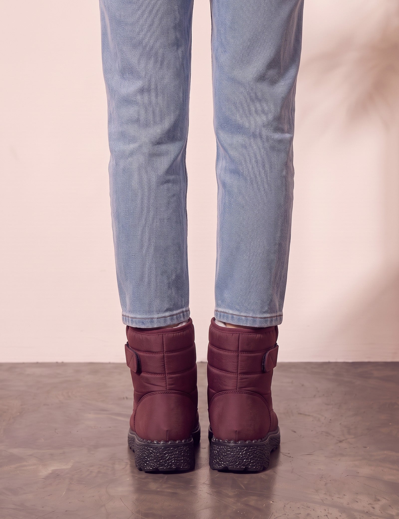 Men's Burgundy Quilted Snow Boots with Ankle Strap, back view of the heels, worn.