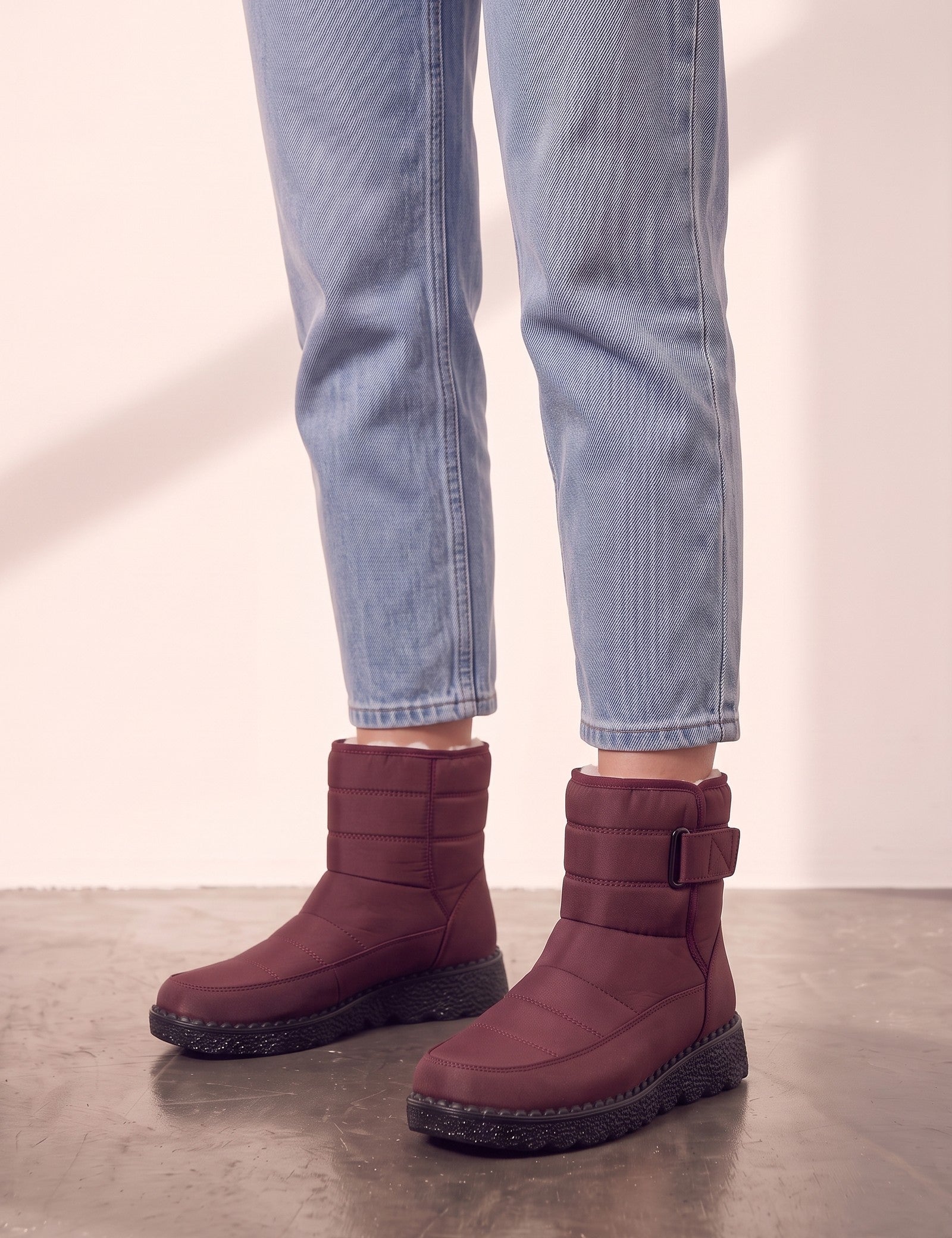 Men's Burgundy Quilted Snow Boots with Ankle Strap, side view of the shoe, worn.