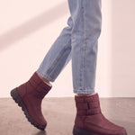 Men's Burgundy Quilted Snow Boots with Ankle Strap, the shoes in mid-step, showing the sole.
