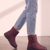 Men's Burgundy Quilted Snow Boots with Ankle Strap, the shoes in mid-step, showing the sole.