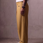 Men's Camel Wide-Leg Pleated Trousers with Button Tabs, side view from the waist down.