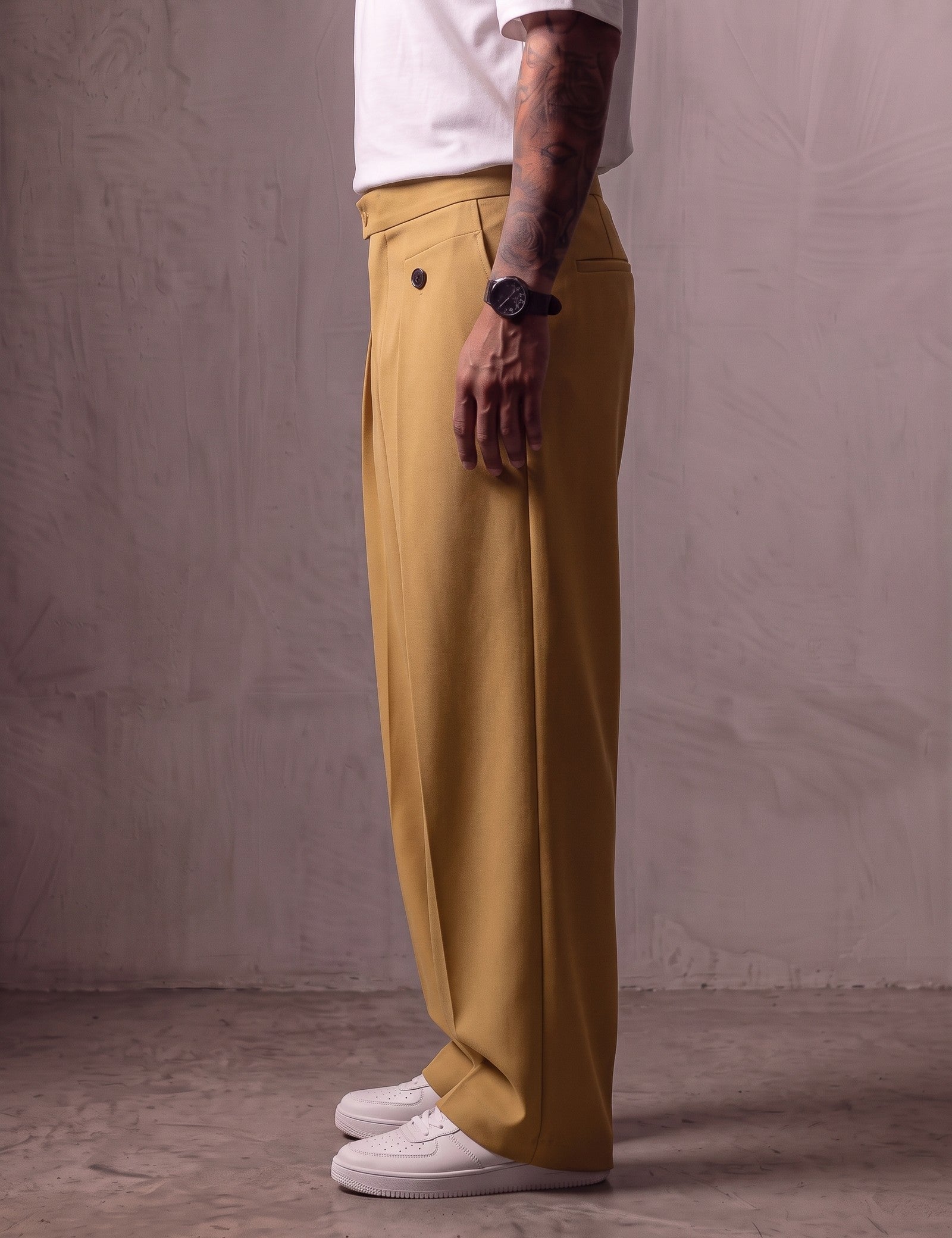 Men's Camel Wide-Leg Pleated Trousers with Button Tabs, side view from the waist down.
