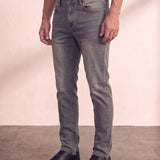 Men's Grey Slim Fit Stretch Denim Jeans, three-quarter view from the waist down.