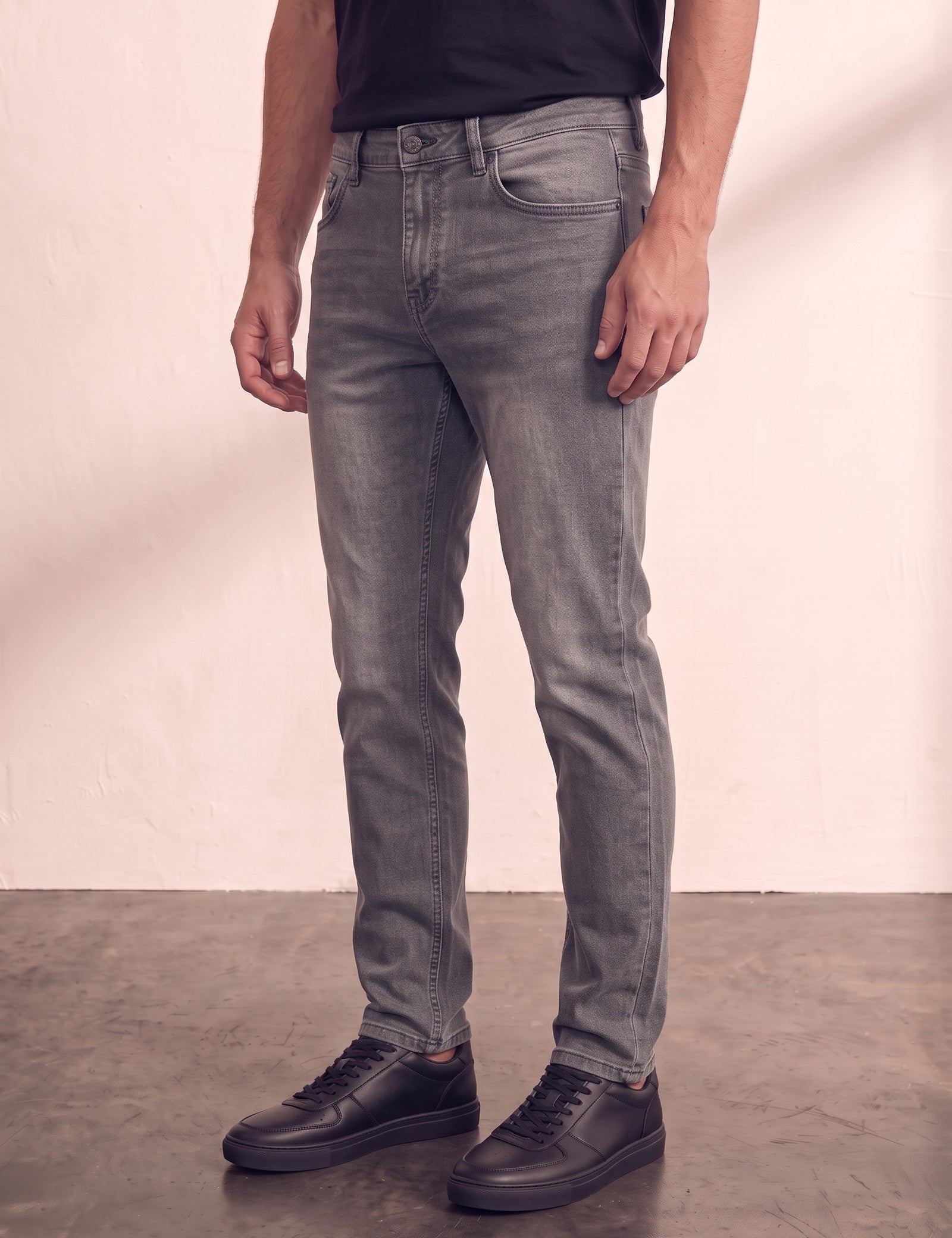 Men's Grey Slim Fit Stretch Denim Jeans, three-quarter view from the waist down.