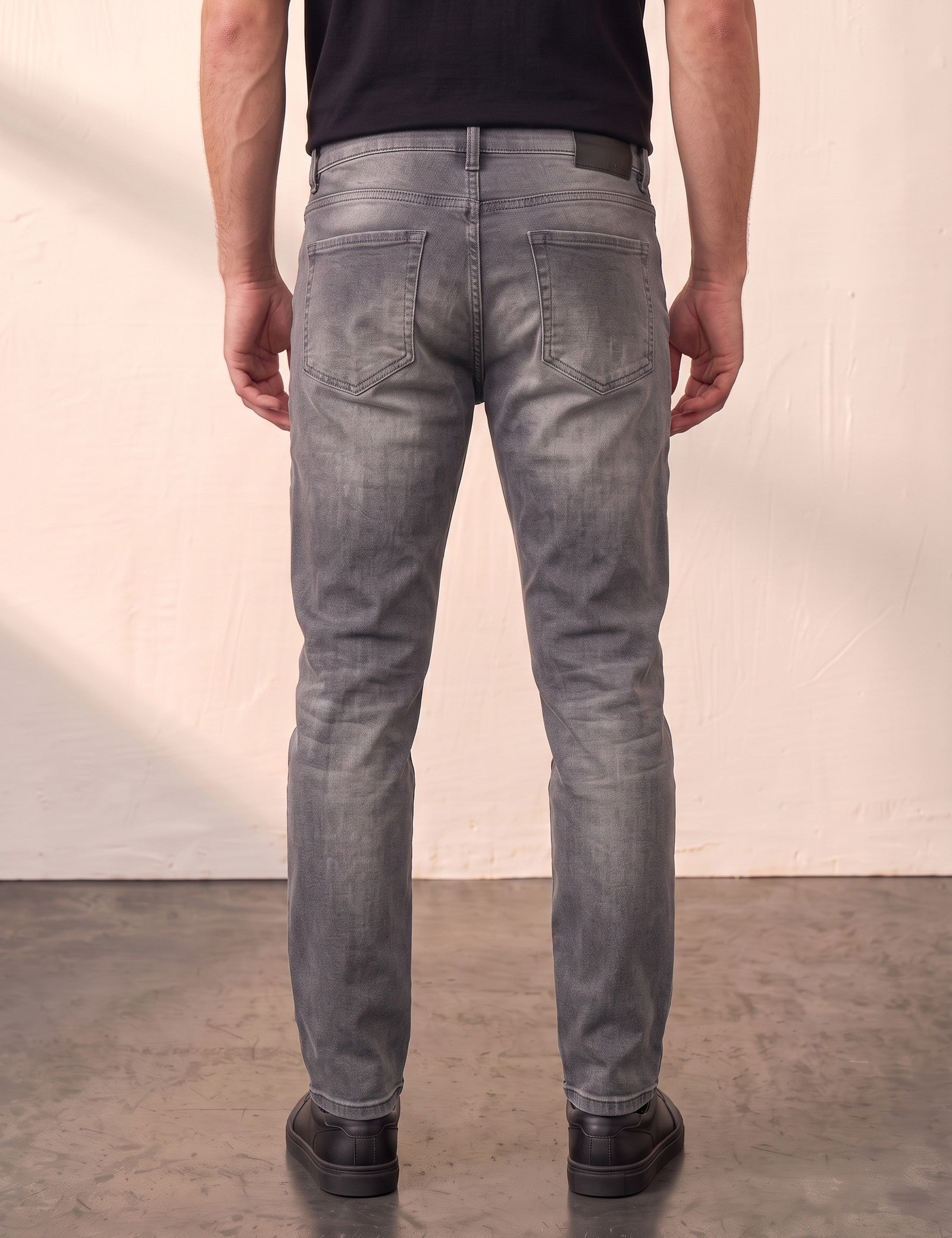 Men's Grey Slim Fit Stretch Denim Jeans, back view from the waist down.