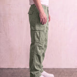 Men's Olive Relaxed Fit Cargo Trousers with Drawcord Hems, side view from the waist down.